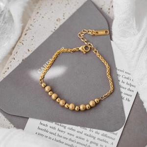 Golden titanium steel bead bracelet featuring alternating matte and polished beads