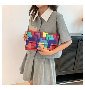 Detailansicht des bunten Karomusters und der goldenen Schnalle an der Clutch-Tasche