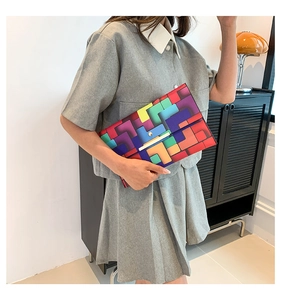 Detailaufnahme einer bunten Patchwork-Clutch mit goldenem Metallverschluss für Damen