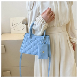 Detail of light blue checkered crossbody bag with matching envelope coin purse charm