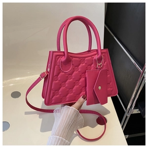 Detail of rose pink plaid quilted handbag with matching mini envelope pouch and gold hardware