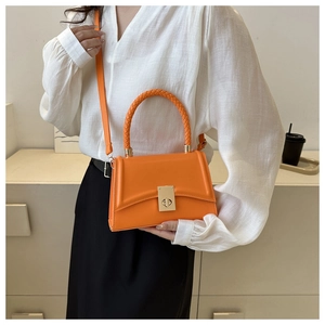 Chic orange trapezoid handbag with woven handle and gold twist lock detail