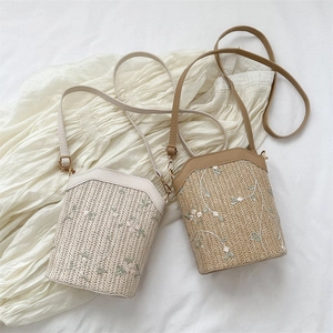 Woven bucket bags with floral embroidery and PU leather straps in beige and khaki