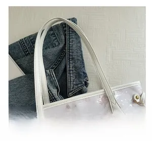 Detail of comfortable double top handles with gold metal buckles on butterfly print bag