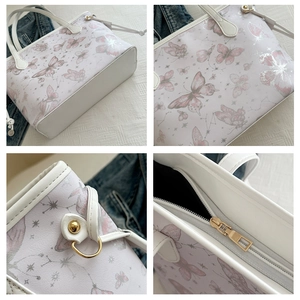 Detail of pink butterfly prints on white faux leather tote with golden zipper closure