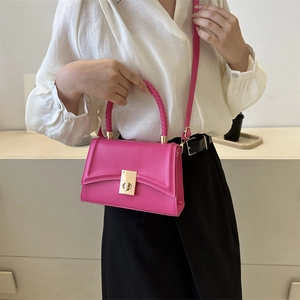Chic magenta square handbag with wave flap, golden twist lock, and woven top handle