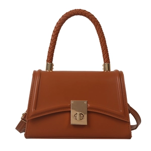 Brown faux leather crossbody square bag with woven handle and gold clasp on white background