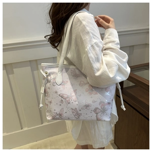 Detail of pink butterfly and constellation prints on the large PU leather tote bag
