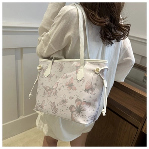 Detailed side view of large butterfly print tote bag with leather straps and drawstring