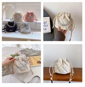 Detailed macro view showing quilted diamond patterns and dual-tone chain handles on bucket bags