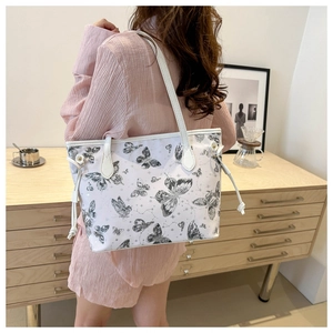 Minimalist white tote bag with black butterfly print and drawstring side details