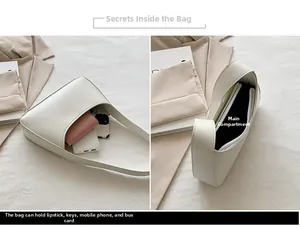Detail view of cream white shoulder bag showing interior space for phone and makeup