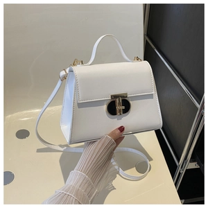 Detail of white leather trapezoid handbag with premium gold and black T-lock closure