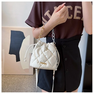 Detail of white quilted bucket bag with golden chain handle and metal JINGPIN logo