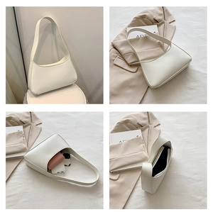 Internal view of minimalist white hobo bag showing spacious capacity for phone and wallet