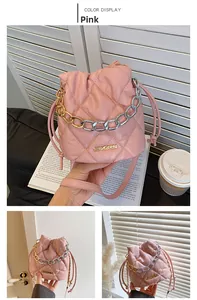 Detailed close-up of pink quilted bucket bag with golden chain and JINGPIN metal logo