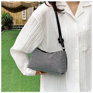 Close-up of sparkling black rhinestone shoulder bag with elegant knot strap detail