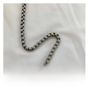 Detailed view of glossy silver box chain shoulder strap for fashion handbags