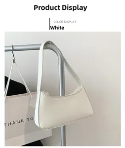Detail view of white minimalist PU leather underarm bag hanging on a silver hanger