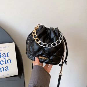 Quilted black bucket bag with drawstring closure and two-tone chunky chain strap
