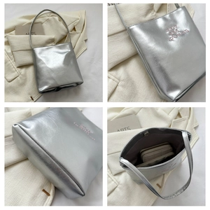 Silver metallic tote bag showing spacious interior with magnetic closure and embroidery