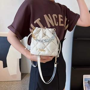 White quilted drawstring bucket bag with gold chain strap and elegant diamond pattern