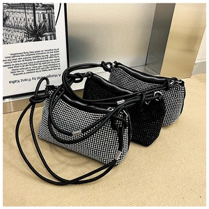Detailed view of rhinestone studded handbags with knotted straps in silver and black