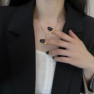 Golden titanium steel necklace with star pendant and rectangular link chain on a model