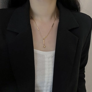 Elegant gold titanium star pendant necklace with fringe chain worn by a model