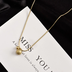 Elegant gold titanium steel snake chain with matte and polished bead pendants on white card