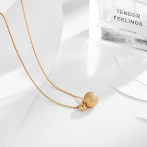 Elegant gold titanium necklace featuring matte and polished beads on a thin snake chain