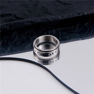 Polished stainless steel spinning ring with black engraved star and moon pattern