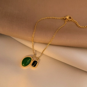 Luxurious titanium gold anklet featuring green and black agate double pendants on silk
