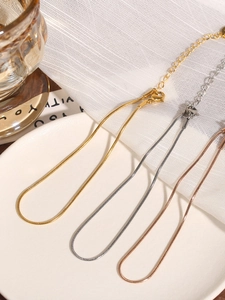 Detailed view of snake bone ankle chains in gold, silver and rose gold finishes