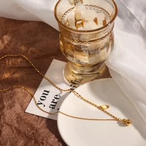18k gold plated stainless steel gourd pendant necklace on elegant warm background