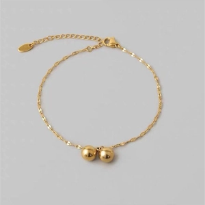 Bracelet de cheville en acier titane doré avec double perles polies et chaîne à pompons