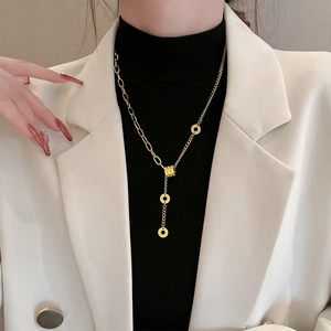 Golden titanium steel Y-shaped necklace with asymmetric chain and ring pendant for women