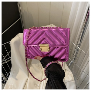 Close-up of metallic purple quilted flap bag with gold chain strap and turn-lock
