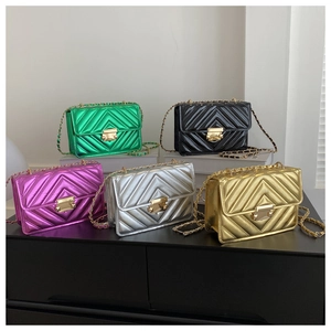 Detail view of five metallic quilted handbags in green, black, purple, silver and gold