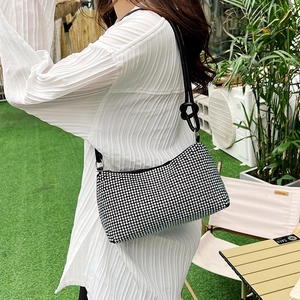 Sparkling silver rhinestone underarm bag with black shoulder strap and knot detail