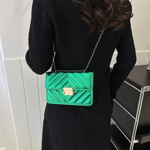 Bright green quilted patent leather crossbody bag with elegant gold chain strap