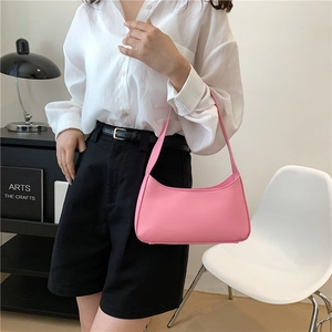 Minimalist pink underarm baguette bag with smooth faux leather finish for women