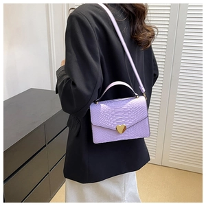 Detail of lavender crocodile texture bag with golden heart-shaped rotating metal buckle