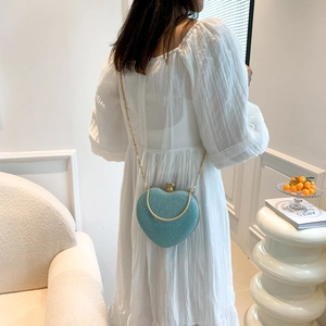 Elegant heart-shaped evening bag in sparkling tiffany blue with a golden chain strap