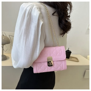 Rear view of a light pink quilted chain bag with gold lock buckle on a female model