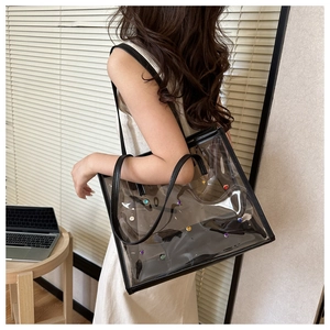 Transparent PVC tote bag with colorful rhinestones shown in a lifestyle office setting