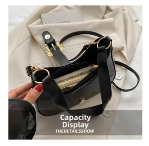 Detailed view of black crocodile texture handbag interior and spacious zipper pocket