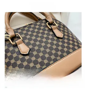 Detailopname van bruine monogram tas met luxe lederen randen en gouden fittingen