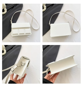 Detail view of white crossbody bag with 3D chocolate grid texture and adjustable strap