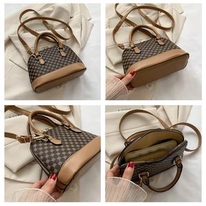 Detail view of vintage patterned shell bag showing internal storage and leather texture